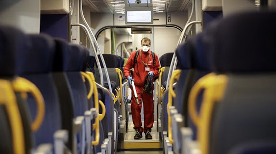 Worker sprays disinfectant on an Italian train.